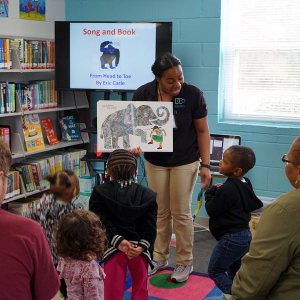 An active storytime, with children enacting the motions from Eric Carle's "From Head to Toe"