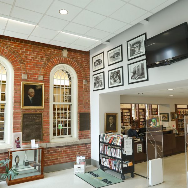 The building lobby, with paintings, photographs, and an entryway into the main space of the building
