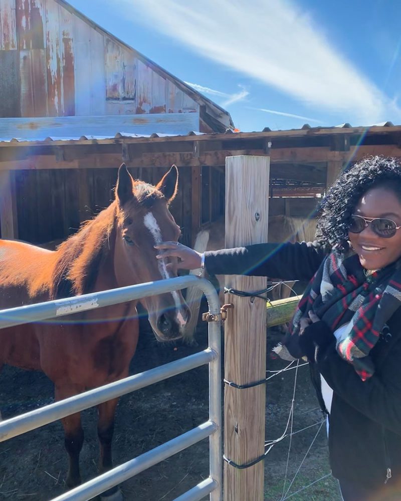 East Regional children's manager Diamond petting one of the equine stars of East Regional's Storytime with Horses