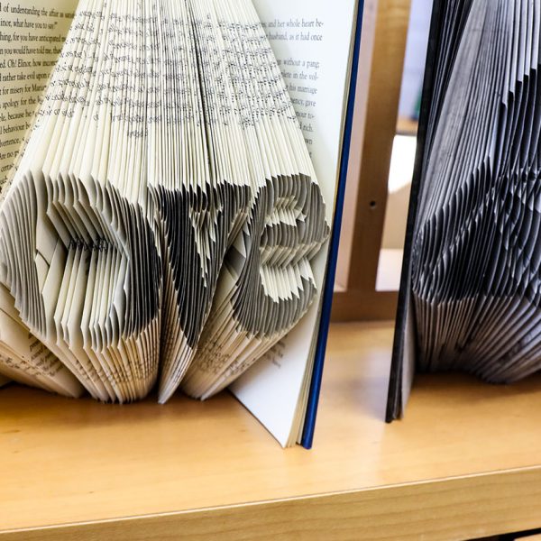 Book art, with pages folded to make the shape of the word "Love"