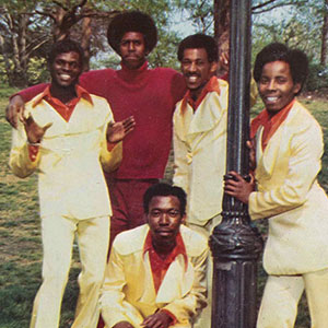 Group photograph of a band with matching outfits