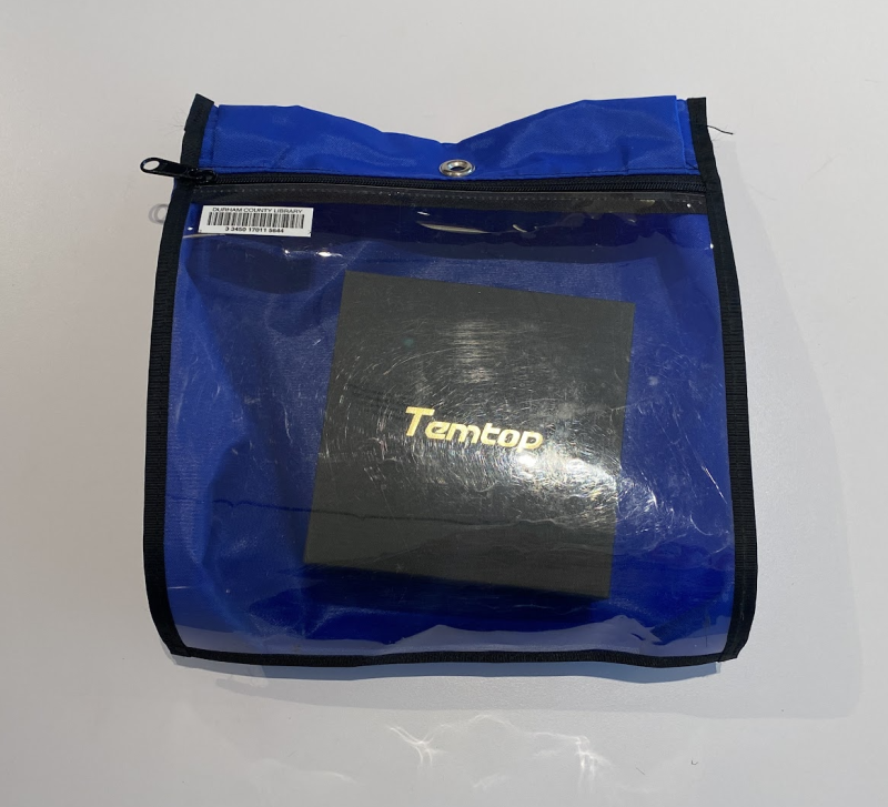 Blue zippered bag with a clear front, showing a black box inside that says Temtop on it.