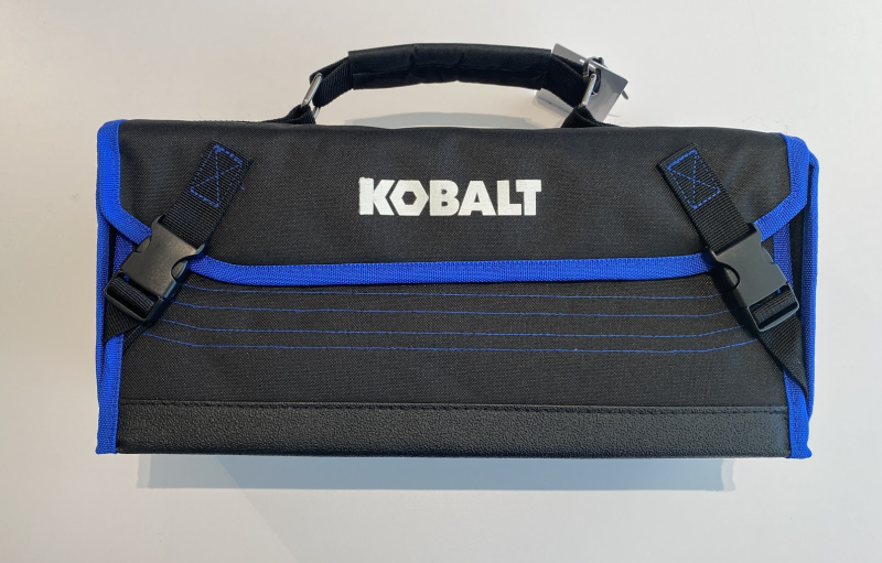 A long cloth case with a handle and buckle closures, saying KOBALT on the front.