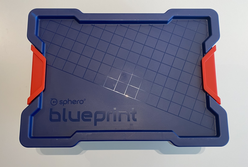 Top of a blue and red plastic bin saying "sphero blueprint" on the lid.