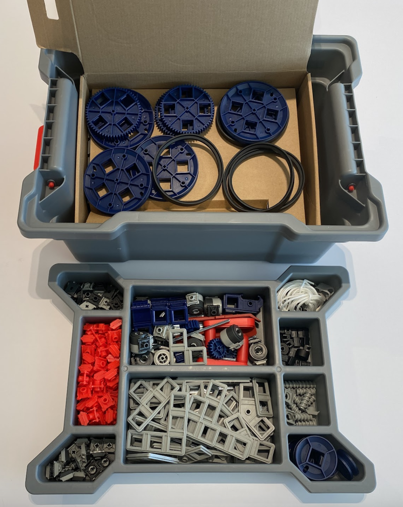 Opened bin showing a variety of plastic parts for building.