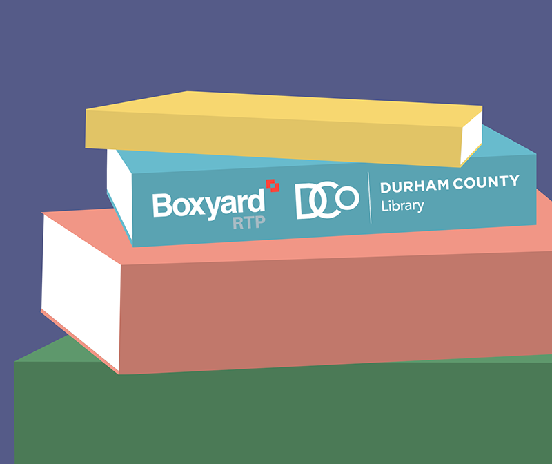 A colorful stack of books. The spine of one has logos reading Boxyard RTP and Durham County Library.