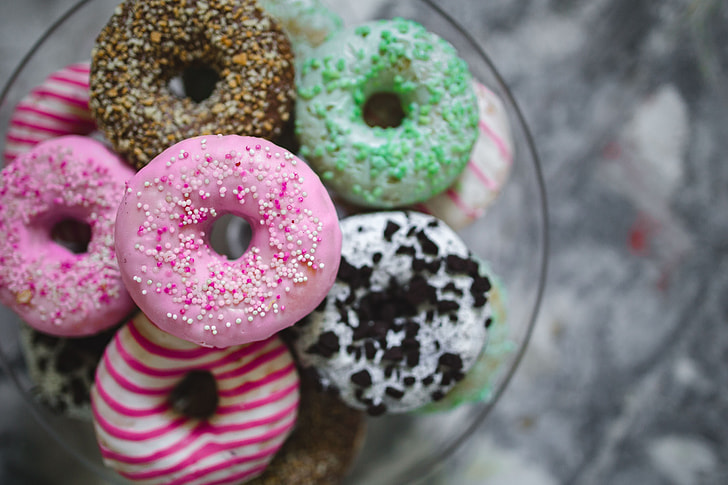 A plate of colorful donuts.