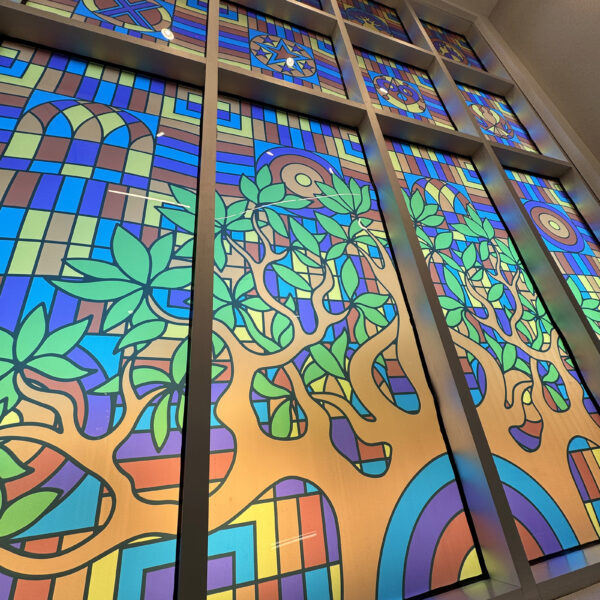 A tall window with stained glass-style decals.